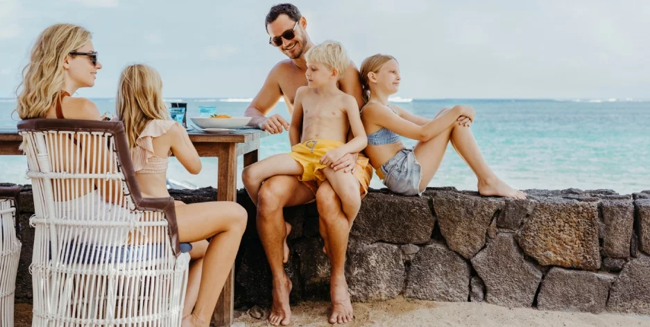 Family enjoying a tropical vacation at Heritage Resort in Mauritius, with children