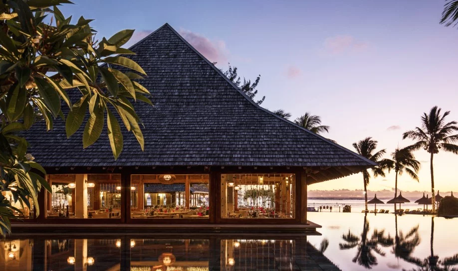 Night view of the all-inclusive Heritage Awali resort under tropical skies