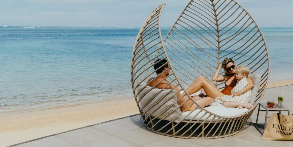 Families celebrating Easter at Heritage Resort in Mauritius, surrounded by turquoise lagoons, tropical gardens and festive beachside activities under the warm island sun