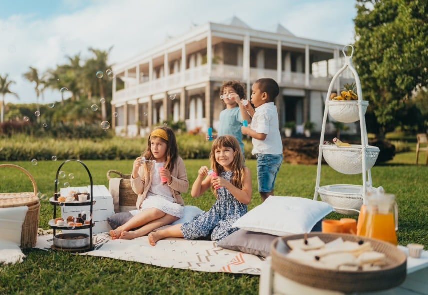 Children having a picnic on the grounds of Le Château de Bel Ombre