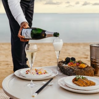 Private beachfront dinner under the stars by the ocean