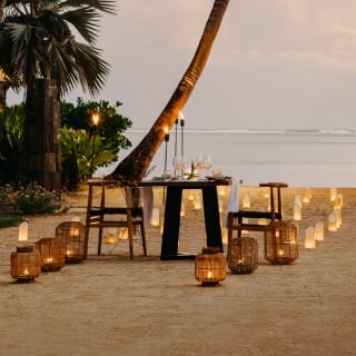 Romantic table set on the beach at sunset