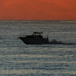 Scenic boat transfer on the beach at twilight