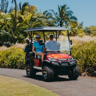Scenic drive through La Réserve Golf Links course at sunset