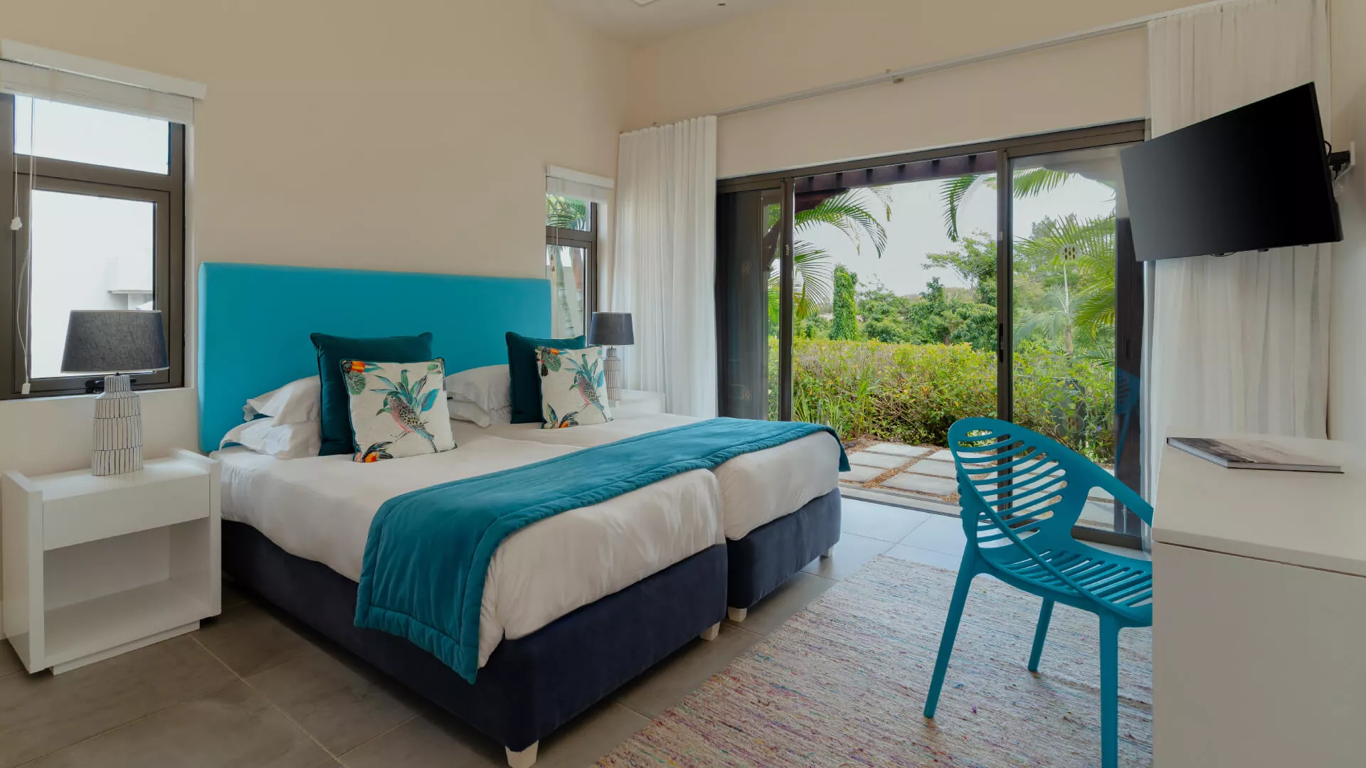Cozy bedroom side view with stylish furnishings in 3 bedroom villa