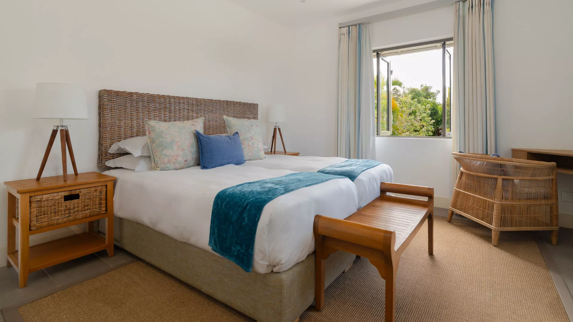 Bedroom in a luxury 4-bedroom villa featuring a bed with a front bench