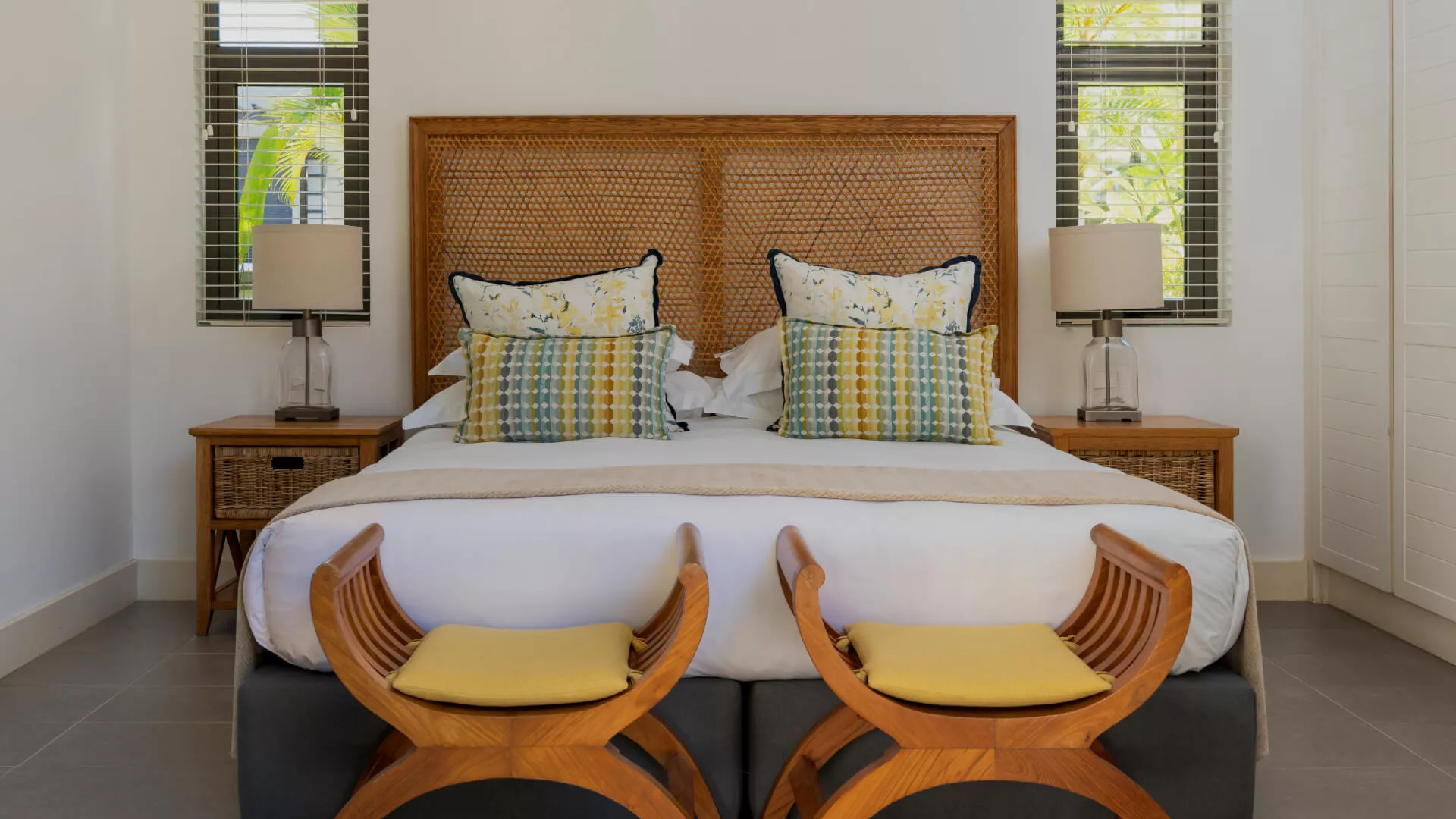 Bedroom in a luxury 4-bedroom villa with two curved benches at the foot of the bed