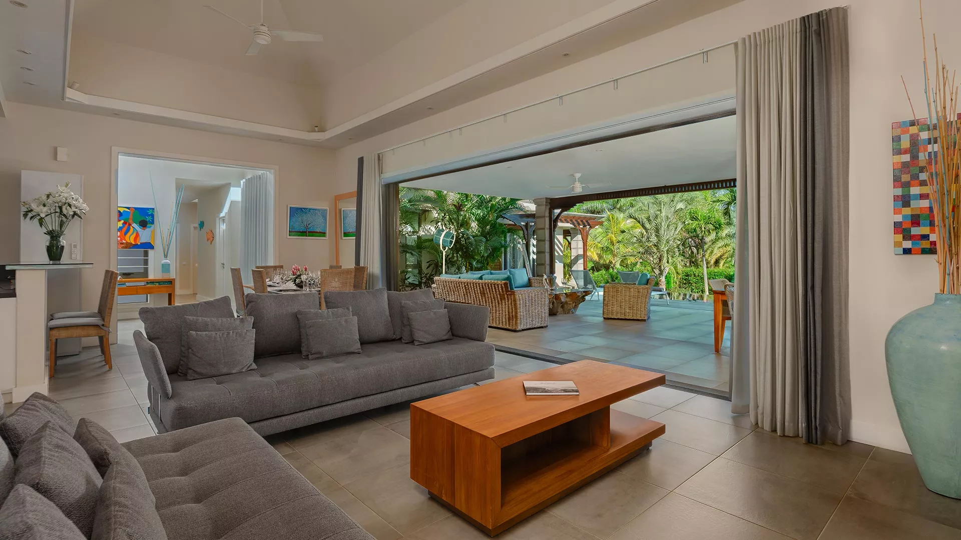 Living room and kitchen of a 4-bedroom villa with pool view at Heritage The Villas, Mauritius