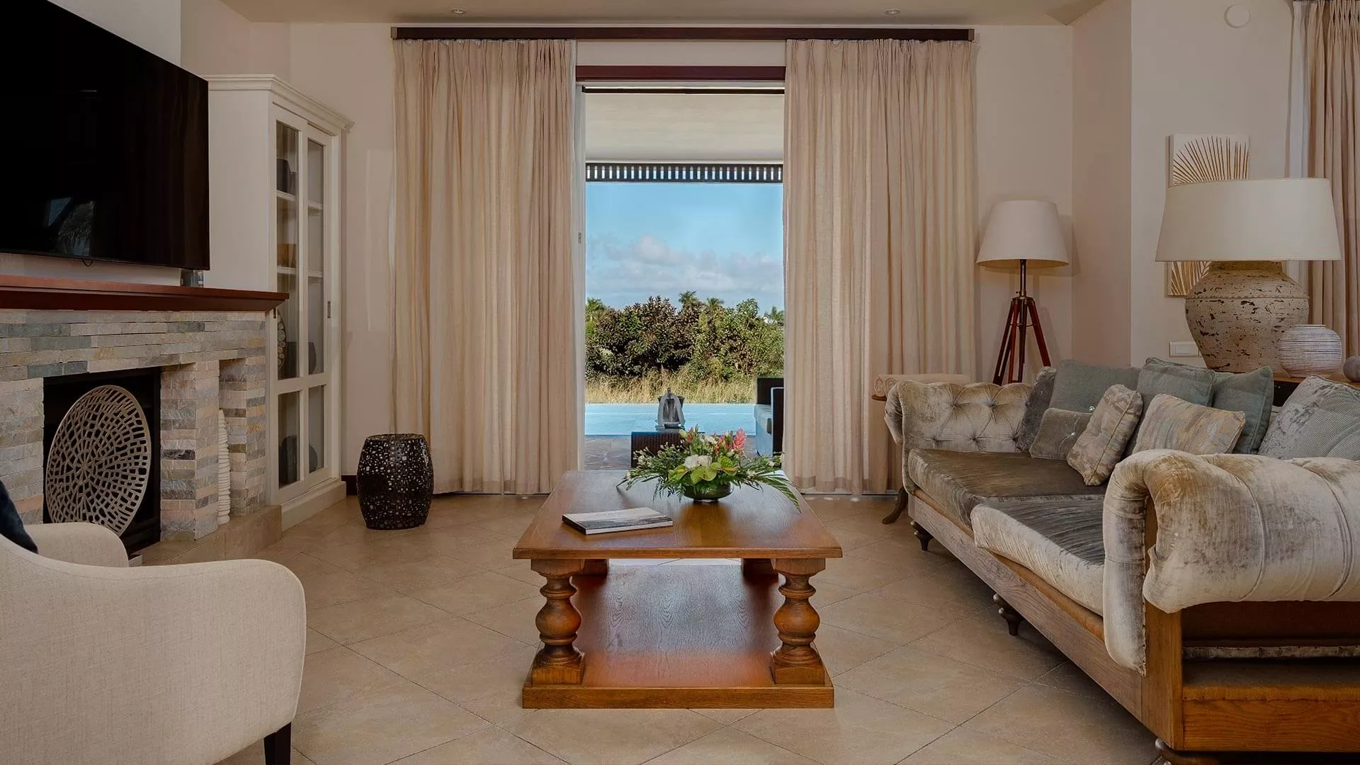 Living room with pool view in a 4-bedroom villa at Heritage The Villas, Mauritius
