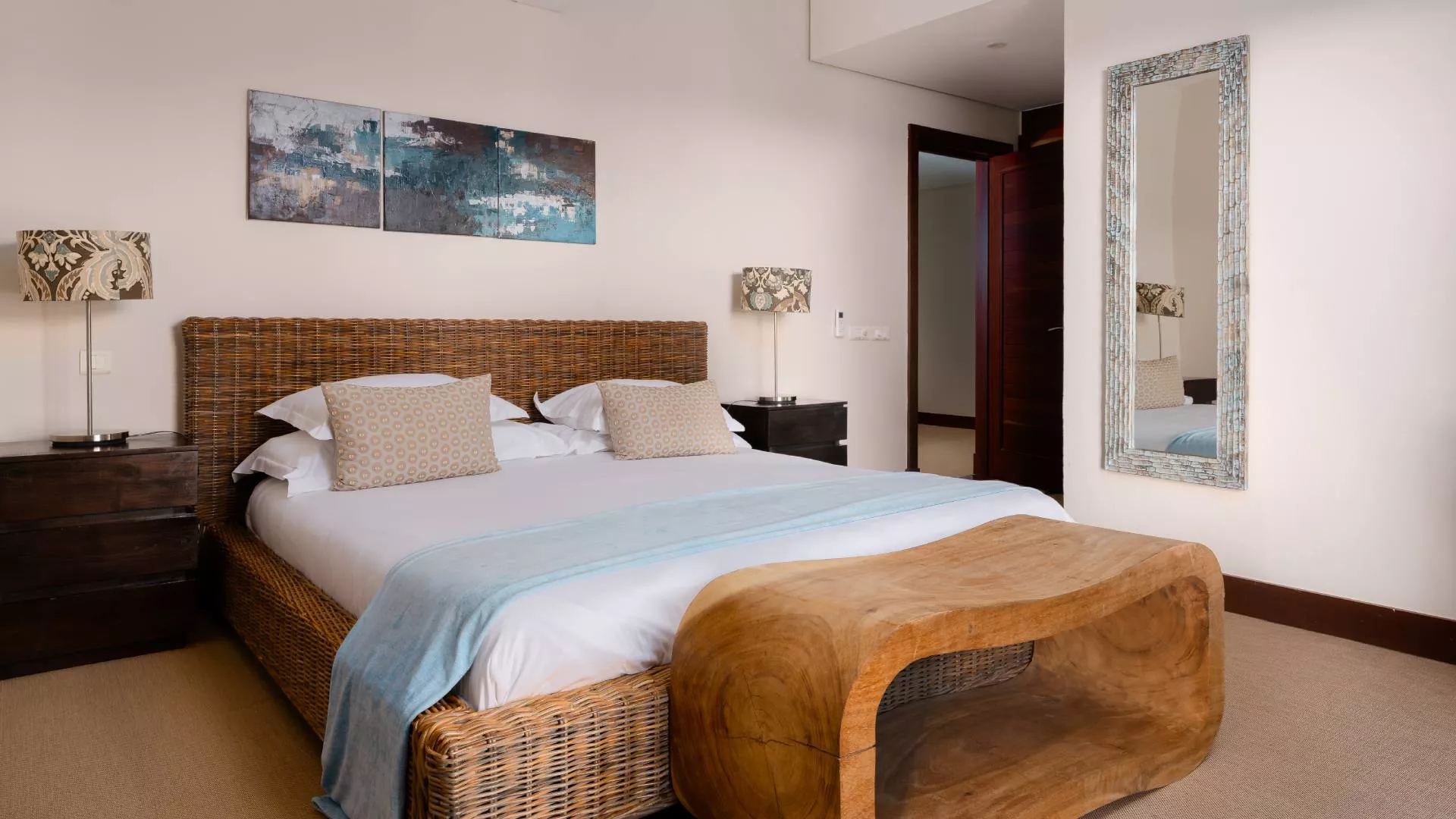 Side-angle interior view of a bedroom in a luxury three-bedroom villa with modern design