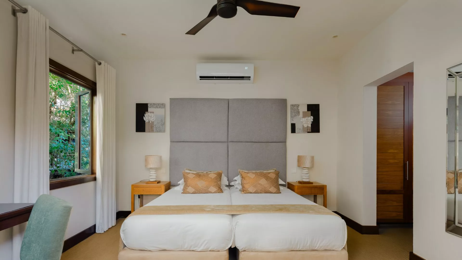 Front-facing view of a top floor bedroom in a luxury three-bedroom villa with contemporary design