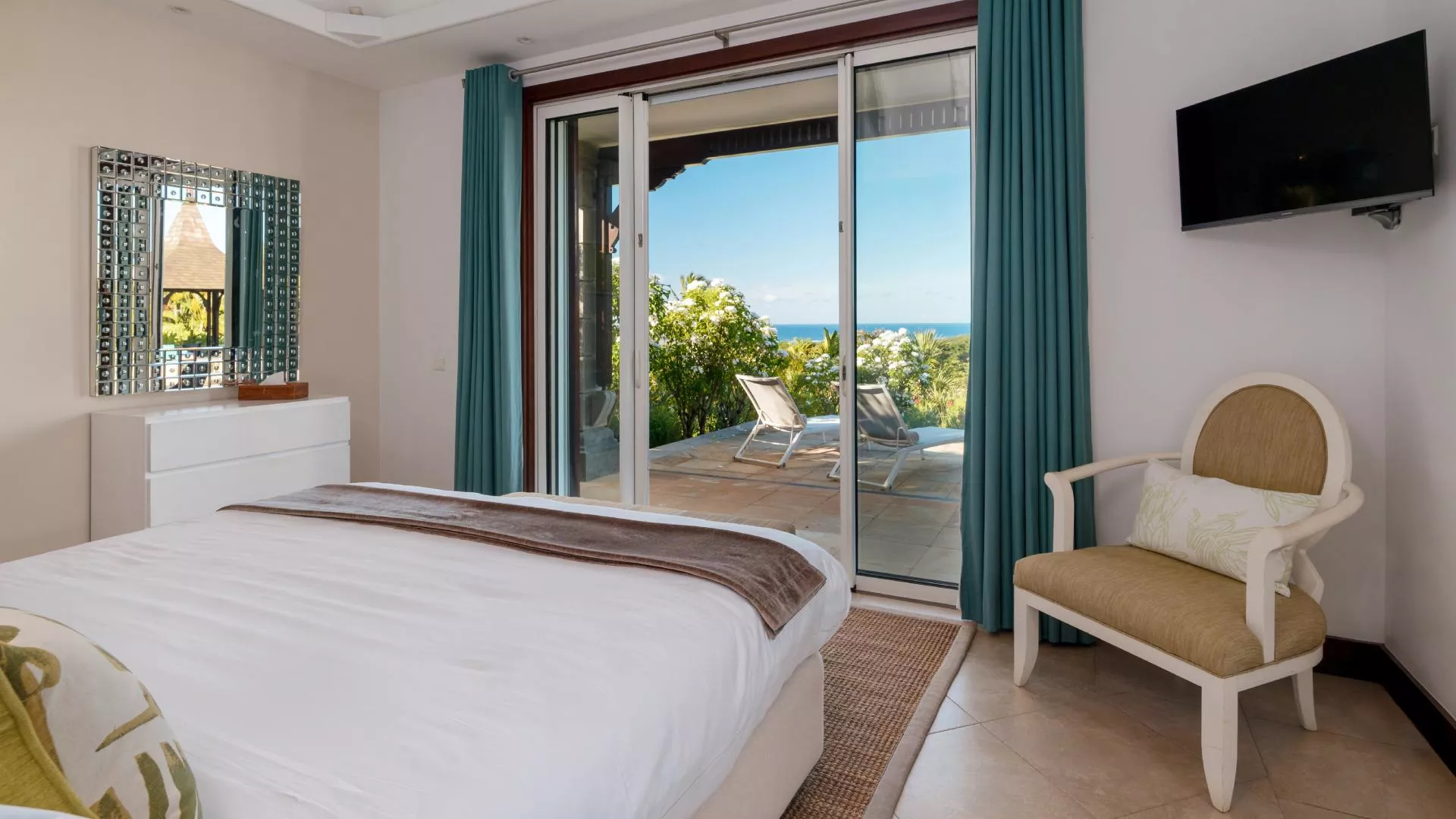 Bedroom with exterior view of the pool in a luxury 4-bedroom villa