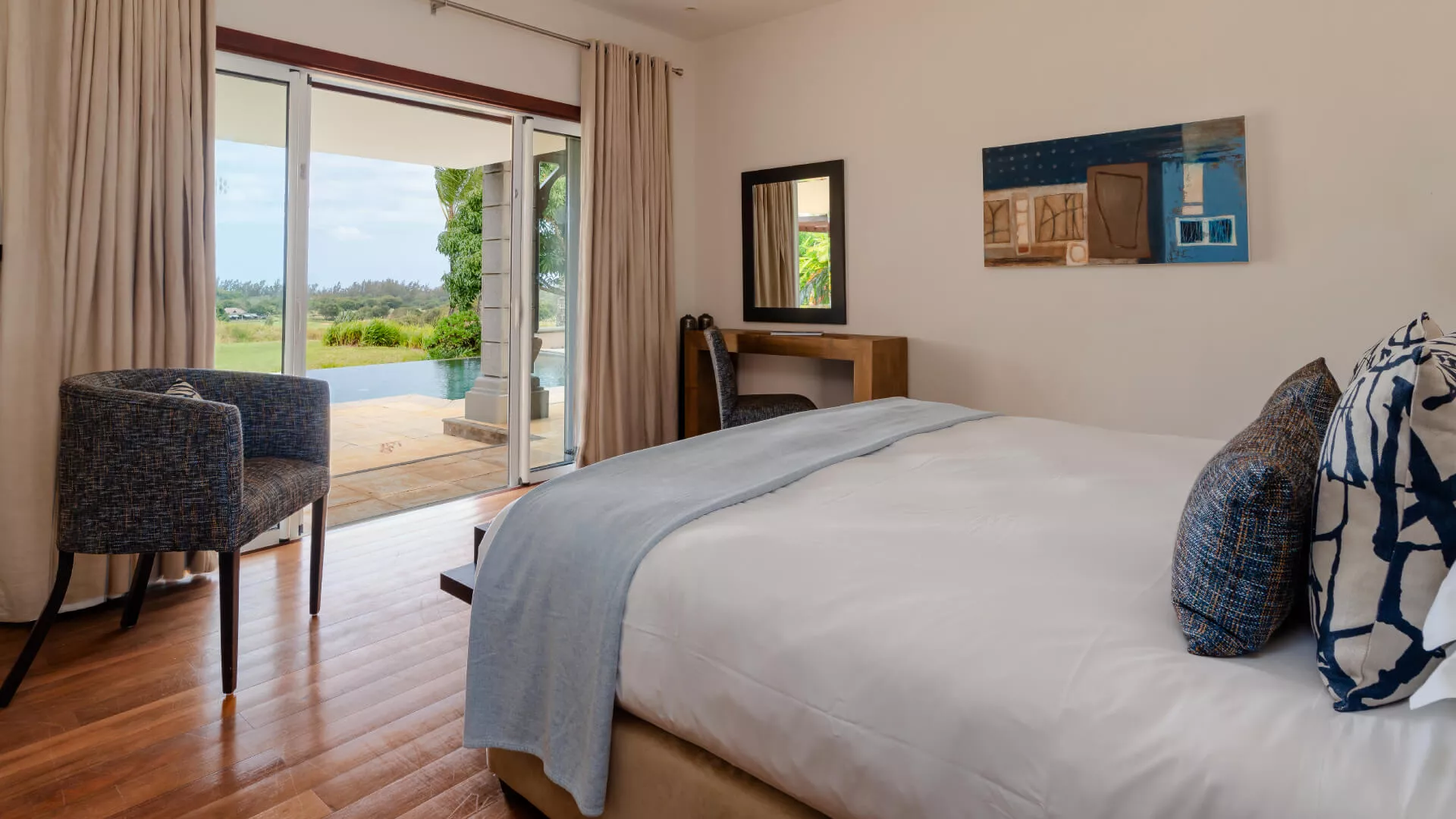 Bedroom with poolside view and bed in a luxury 4-bedroom villa