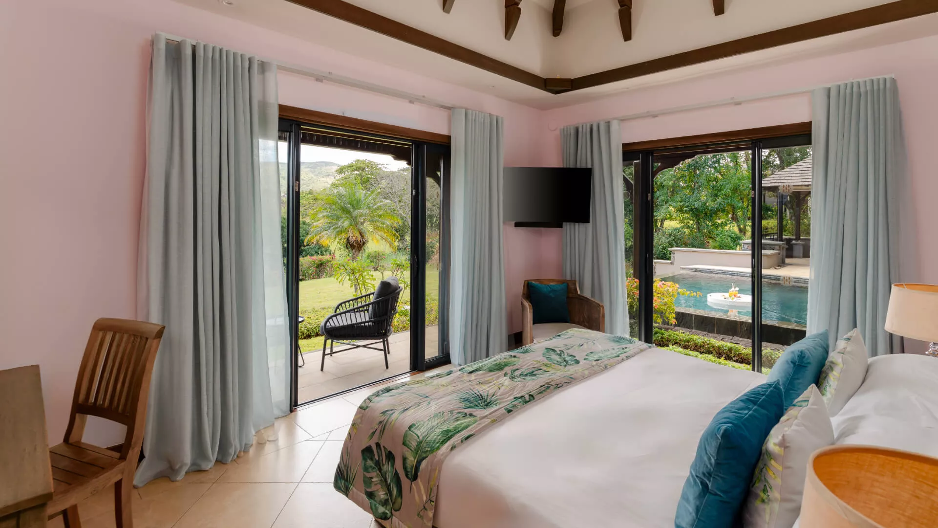 Bedroom with poolside view in a luxury 4-bedroom villa