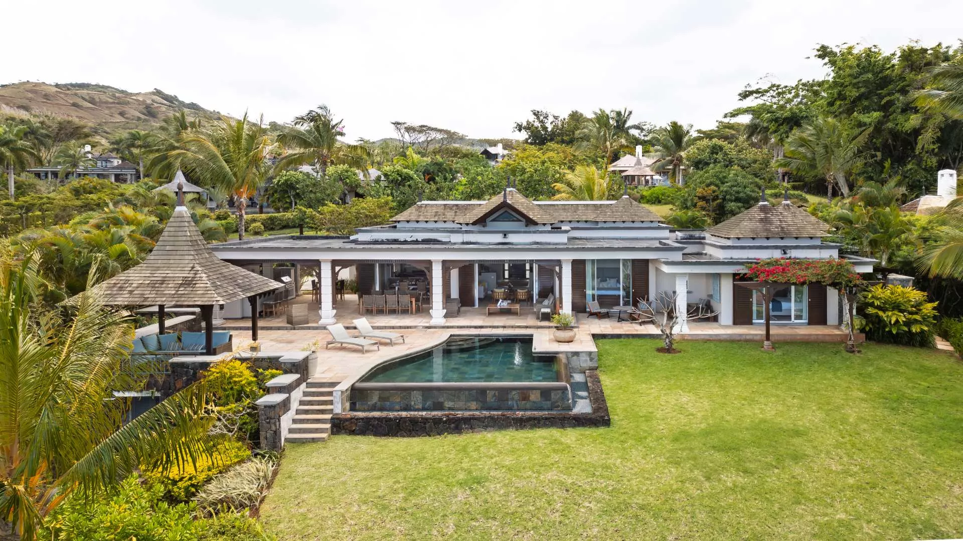 Exterior landscape view with poolside of a luxury 4-bedroom villa
