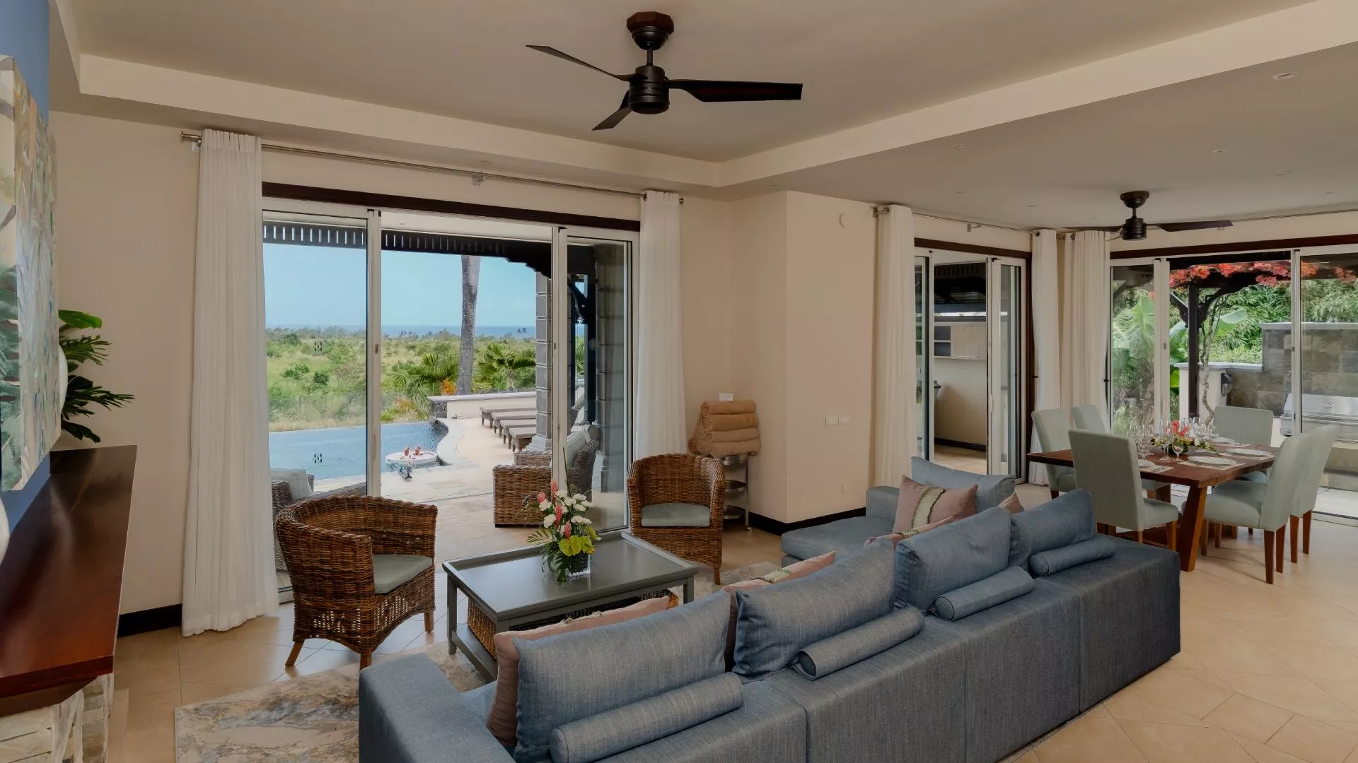 Wide-angle view of the living room in a luxury four-bedroom villa with contemporary furnishings