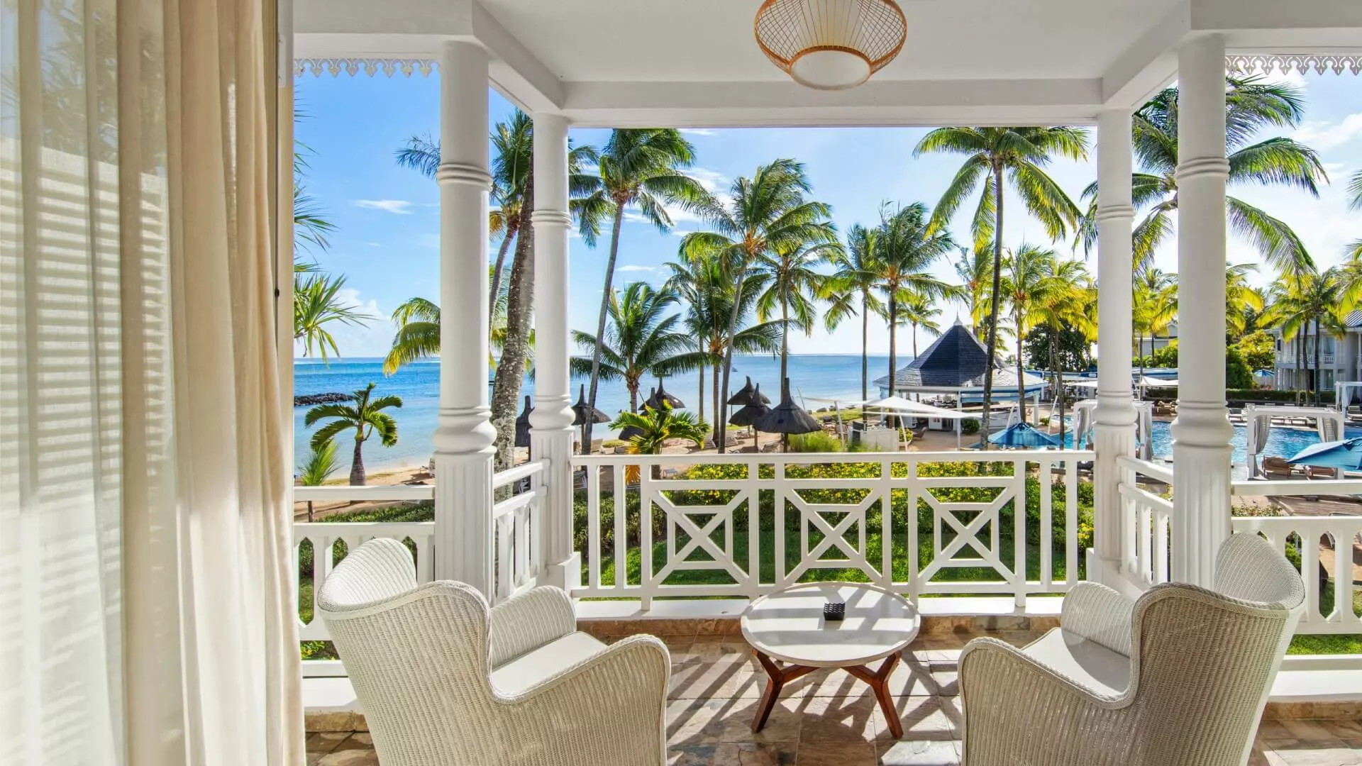 deluxe suite upper floor with ocean facing balcony and comfortable outdoor seating space