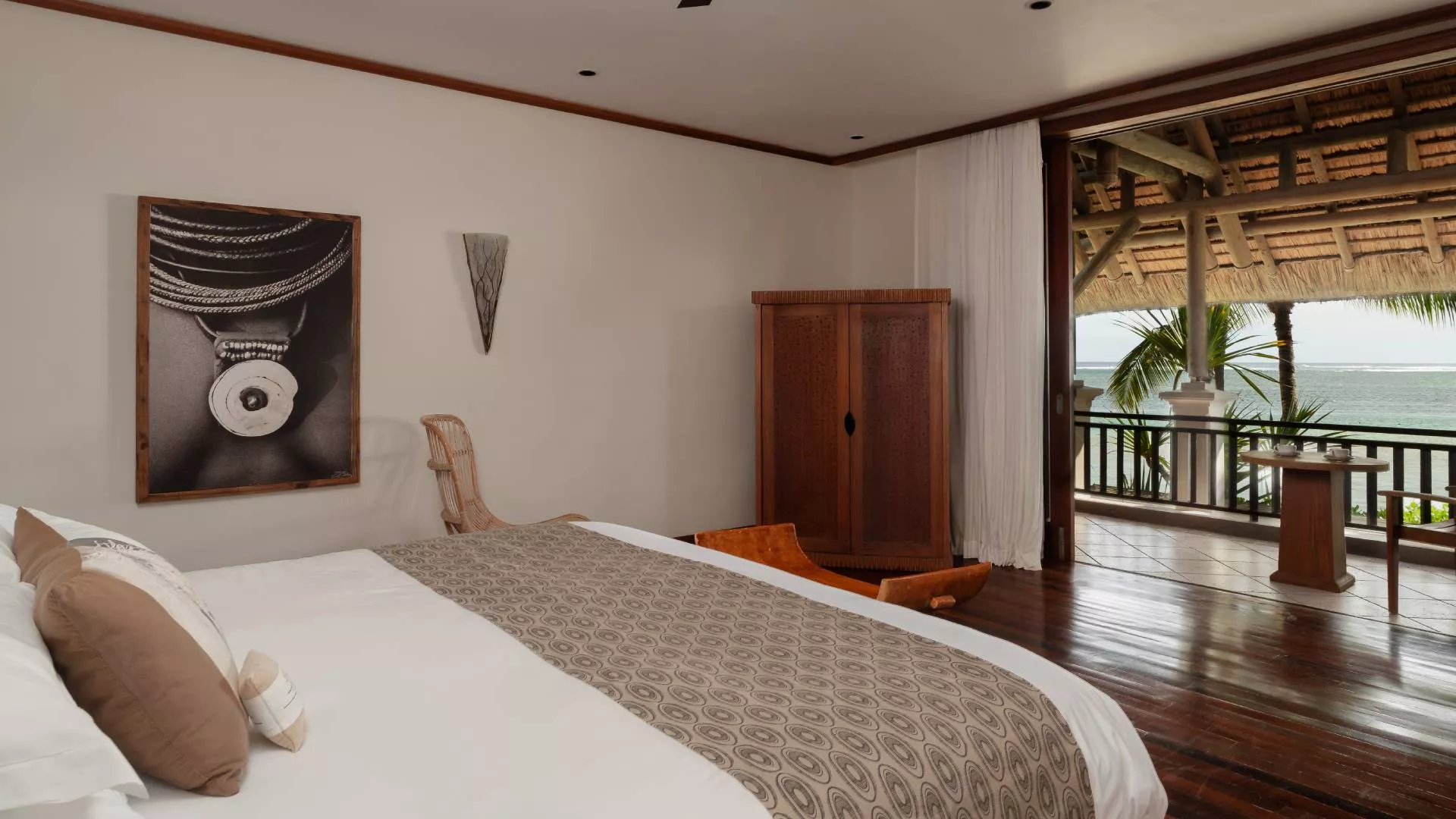 beachfront villa bedroom with private balcony overlooking the ocean