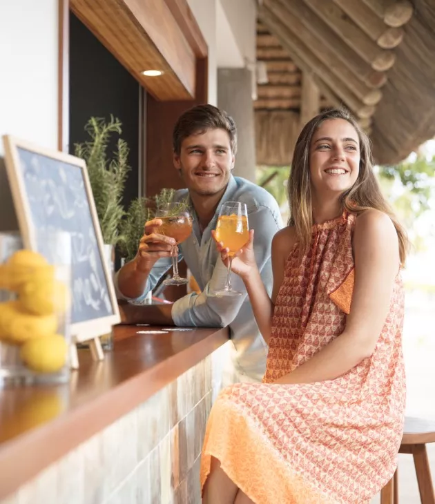 Couple enjoying a cocktail at the bar of C Beach Club