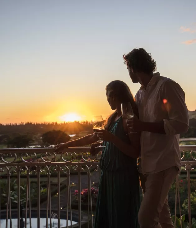 Couple at the Chateau de Bel Ombre drinking wine at Sunset