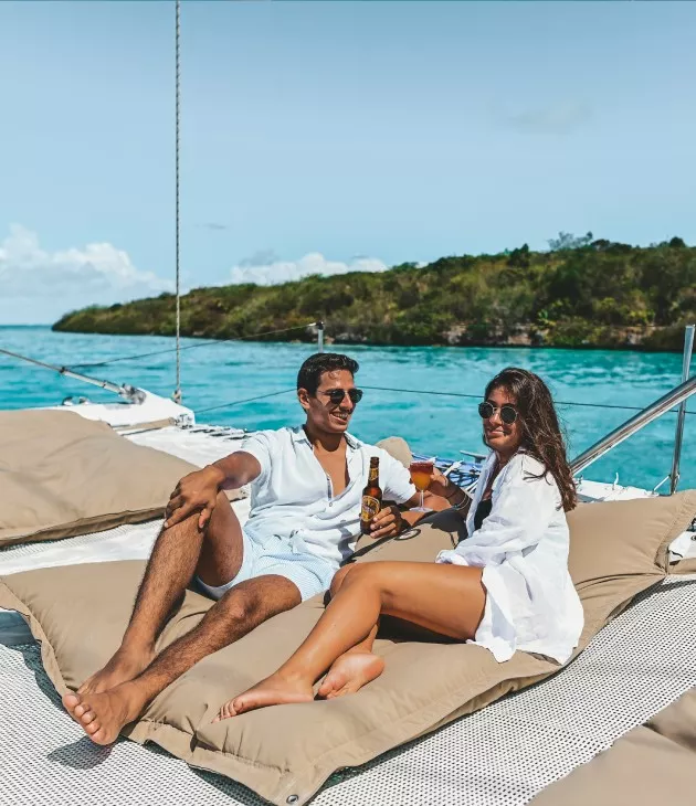 Couple enjoying drinks on catamaran