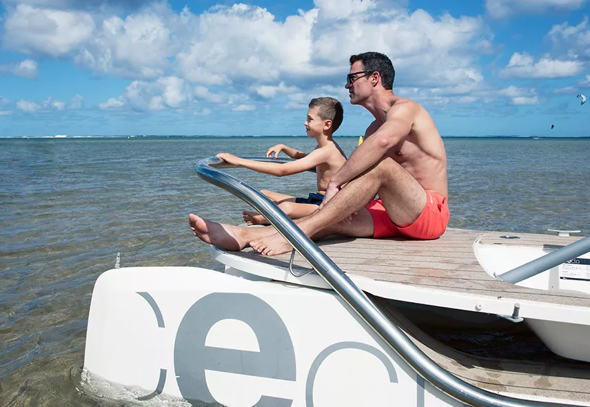 Father and son spending time together on a boat sailing with dad