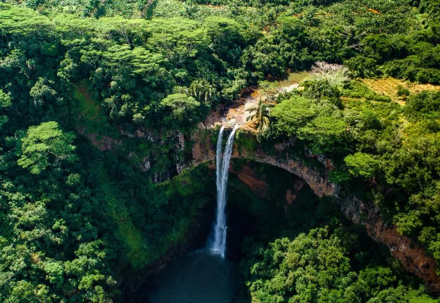 Aerial view of Chamarel Waterfall surrounded by lush greenery in Mauritius