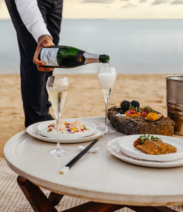 Beachfront private dining with a cocktail being served