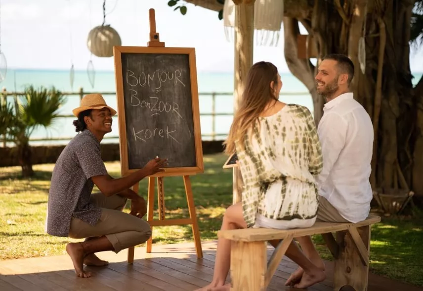 Tourists learning the Creole language with a local instructor in Mauritius