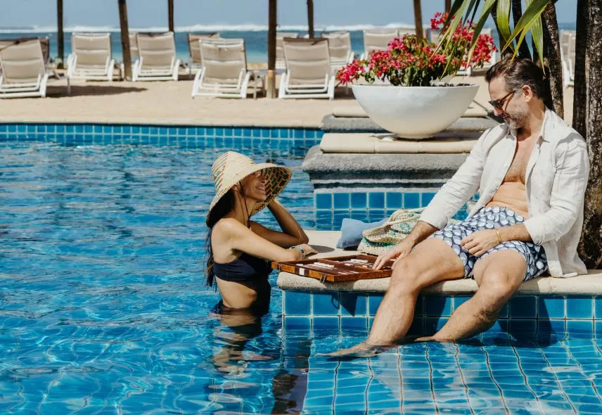Couple sharing a romantic poolside moment during holidays in Mauritius