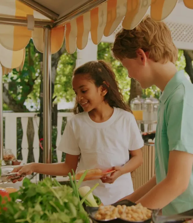 Kids enjoying a playful dining experience at the Timomo Kids Club