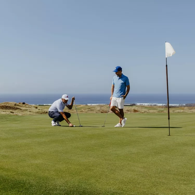 Golfers playing a round of golf on a sunny course - Heritage Golf Club