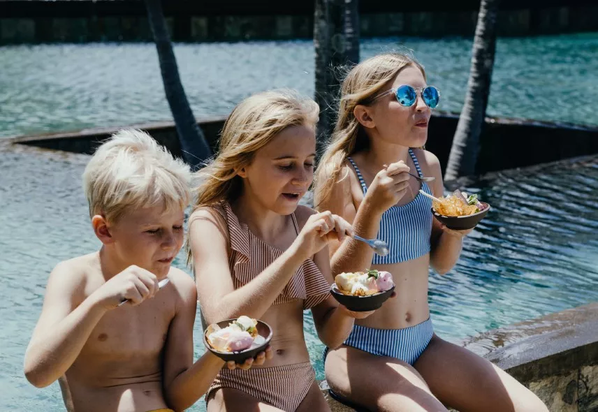 Kids enjoying snacks by the poolside - Heritage Awali