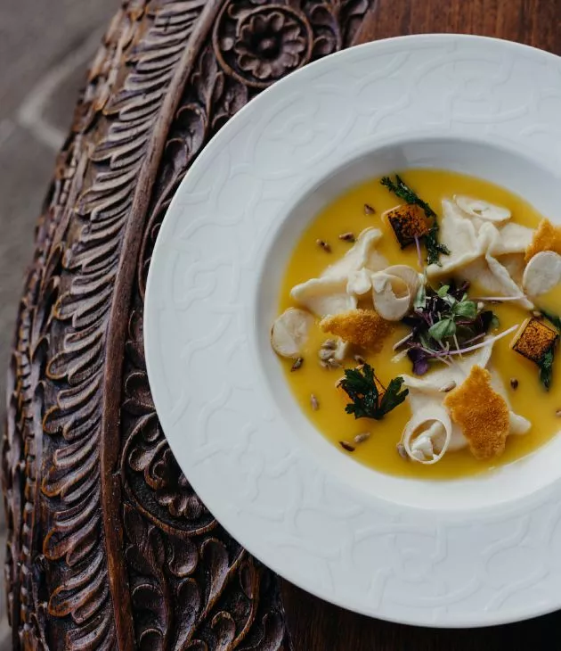 gastromic dish with yellow sauce le château de bel ombre 