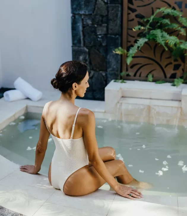 woman relaxing after massage at swimming pool heritage resorts wellness spa