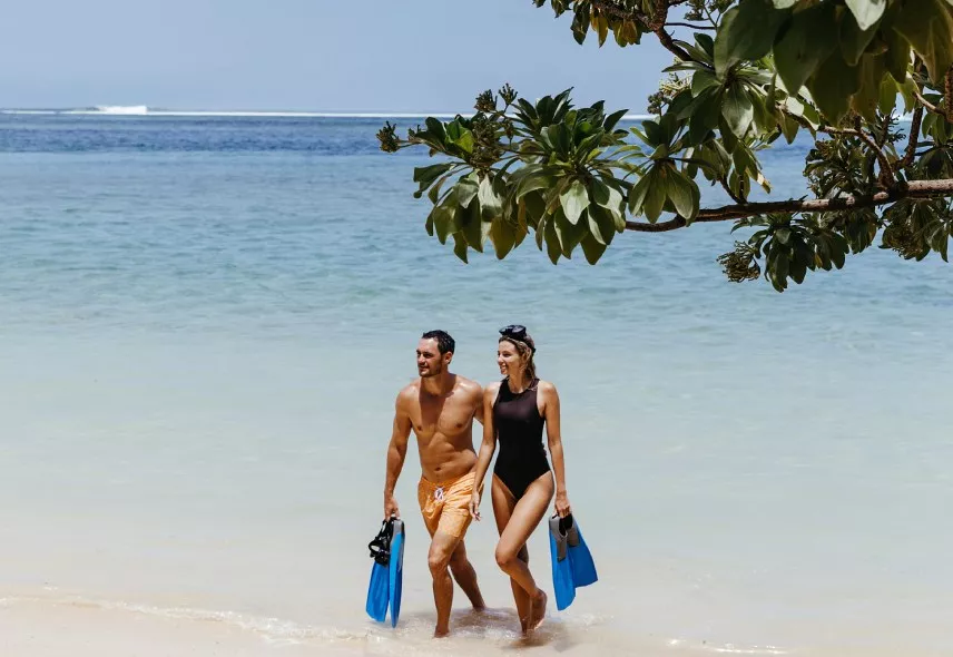 couple in snorkelling equipments at heritage resorts beach 