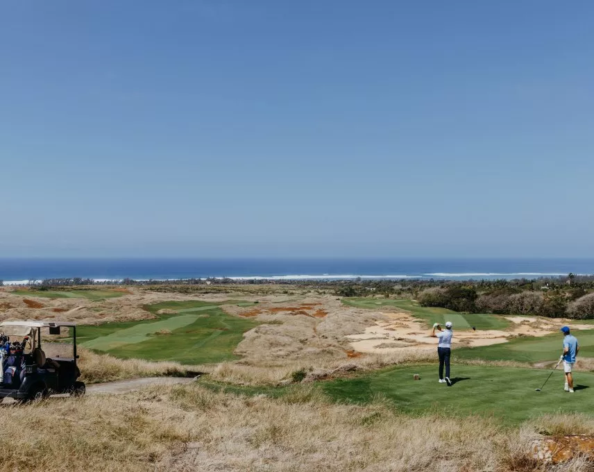 golfers playing at the Heritage Golf Club Mauritius overlooking the Indian Ocean