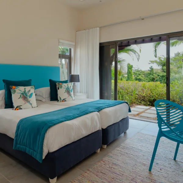 Cozy bedroom side view with stylish furnishings in 3 bedroom villa