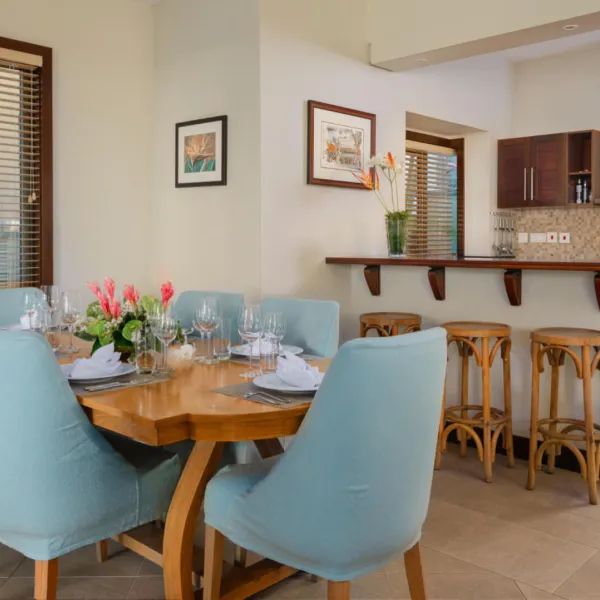 Dining area with table in a three-bedroom villa at Heritage The Villas, Mauritius