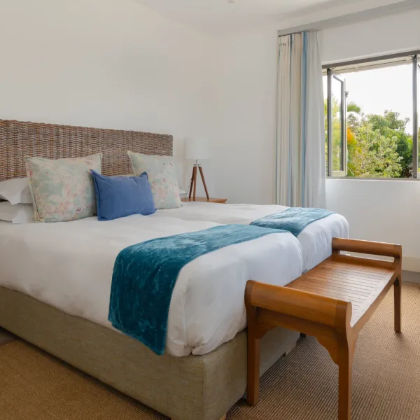 Bedroom in a luxury 4-bedroom villa featuring a bed with a front bench