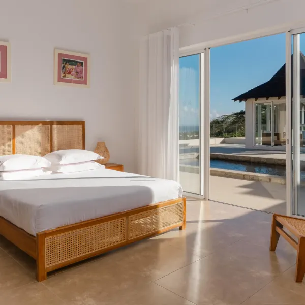 Bedroom with side exterior view overlooking the pool in a luxury 4-bedroom villa