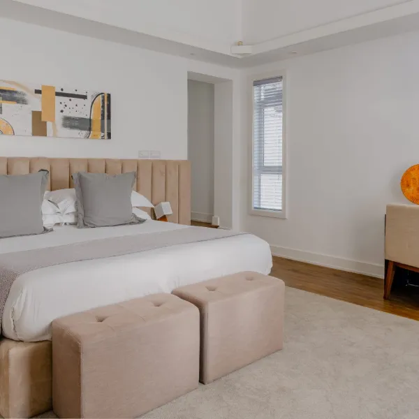 Side view of a bedroom in a four-bedroom villa featuring modern interior design and natural light