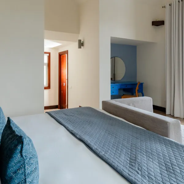 Side view of a top floor bedroom in a luxury four-bedroom villa featuring balcony access