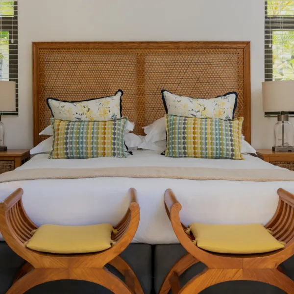 Bedroom in a luxury 4-bedroom villa with two curved benches at the foot of the bed