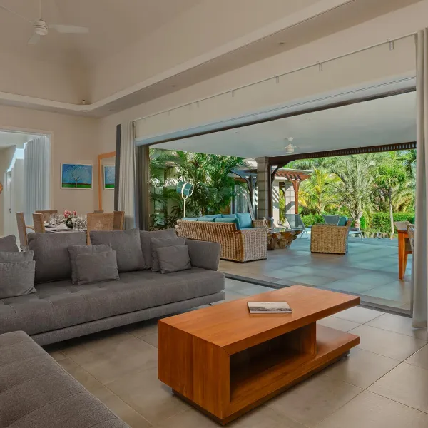 Living room and kitchen of a 4-bedroom villa with pool view at Heritage The Villas, Mauritius
