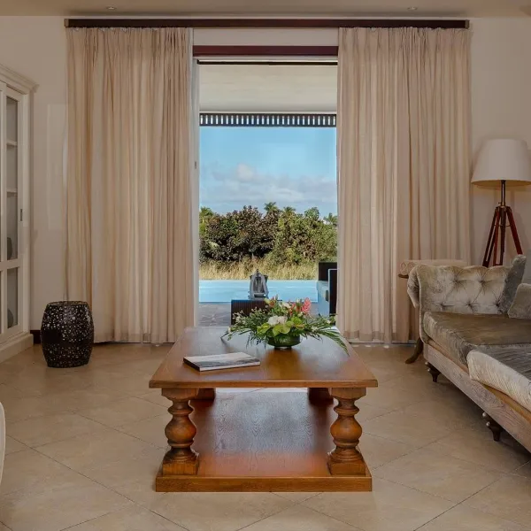 Living room with pool view in a 4-bedroom villa at Heritage The Villas, Mauritius