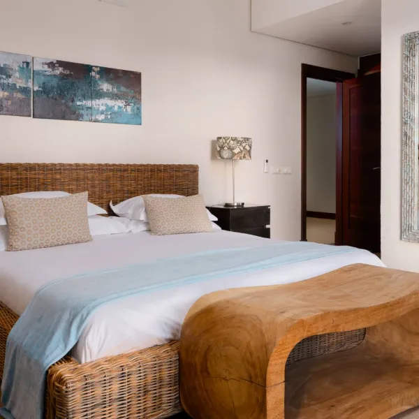Side-angle interior view of a bedroom in a luxury three-bedroom villa with modern design