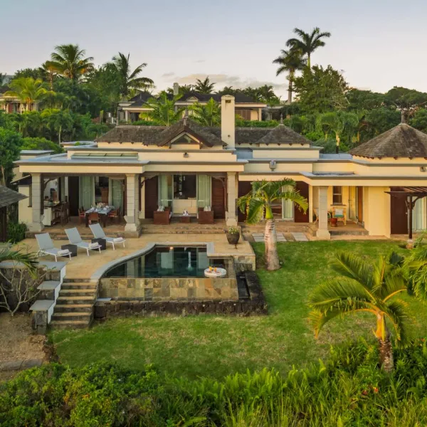 Exterior landscape view of a luxury three-bedroom villa surrounded by lush greenery