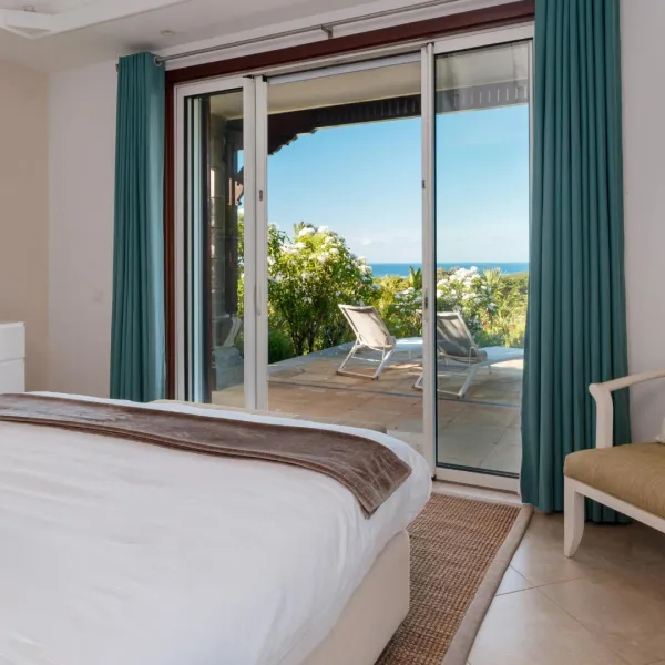 Bedroom with exterior view of the pool in a luxury 4-bedroom villa