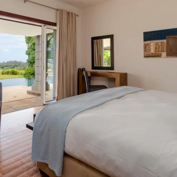 Bedroom with poolside view and bed in a luxury 4-bedroom villa